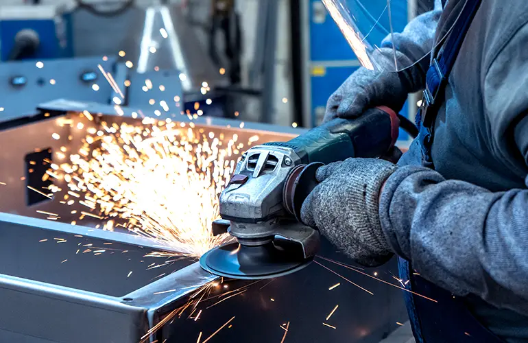 Finishing a welded assembly with an angle grinder