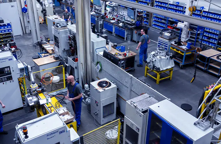 Skilled workers are working in the tool turret assembly area. Test benches ensure proper function and precision.