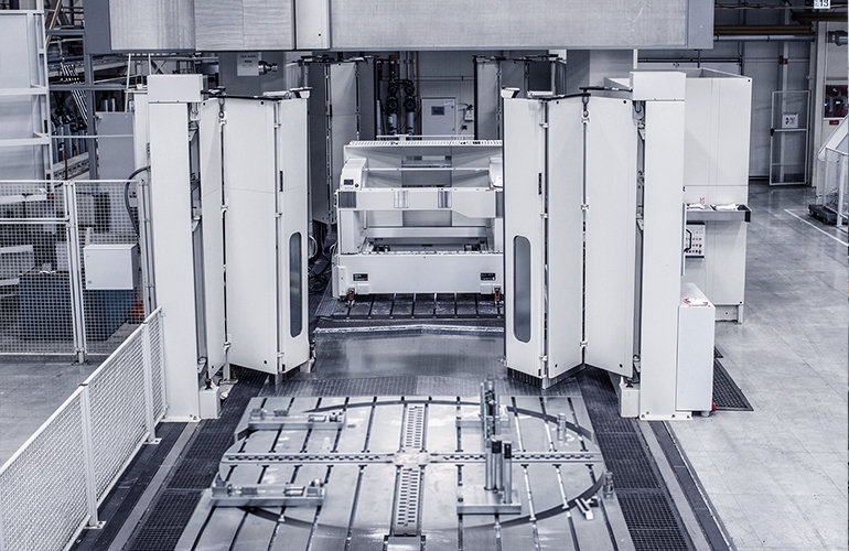 Large portal milling machine in a manufacturing facility. It performs machining of heavy components with high precision.